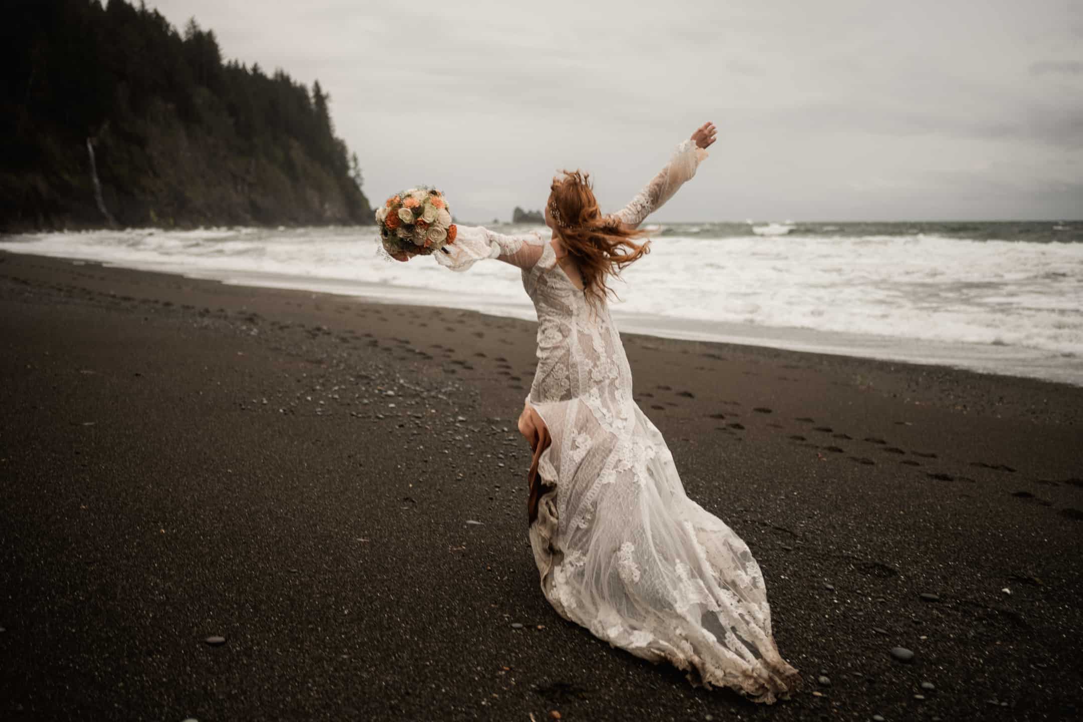 Bride running cheerfully on the beach with the bridal bouquet