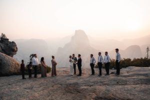 couple standing in front of glacier point in yosemite for their intimate wedding ceremony