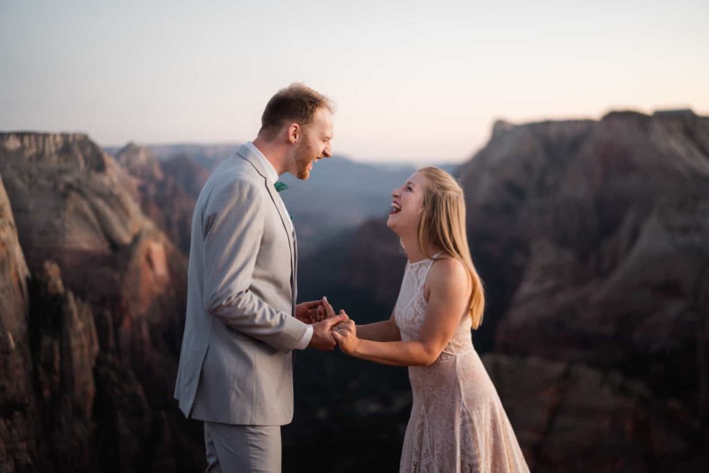 couple bride and groom standing on top of the mountain